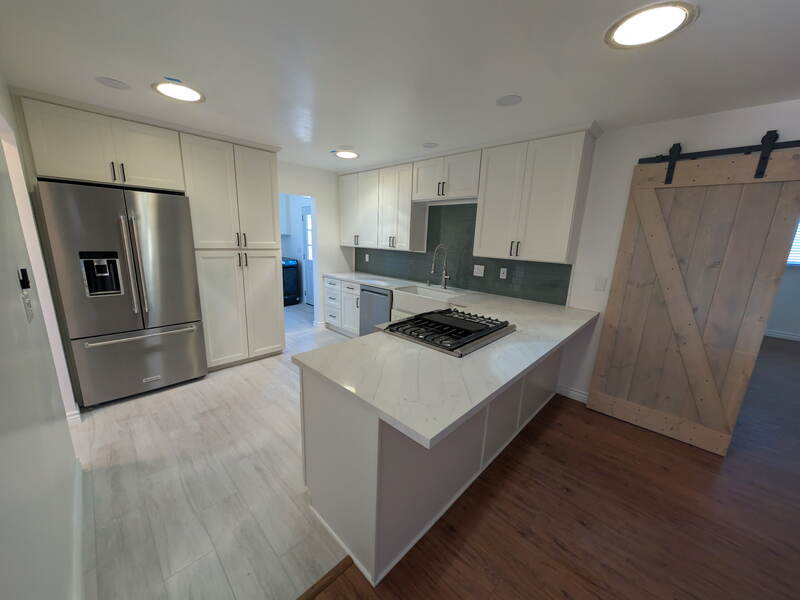 Kitchen Remodel — White shaker cabinets, quartz peninsula, barn door
