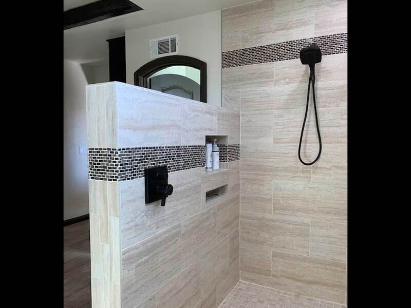 Luxury Master Bath Shower — Travertine tile with mosaic accent, black fixtures